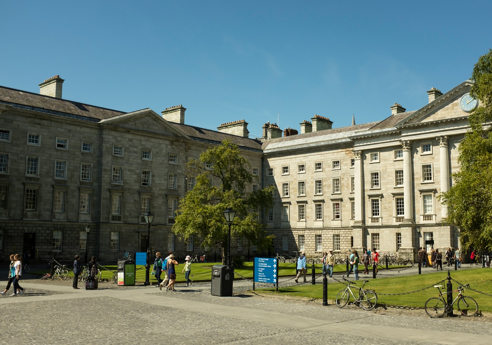 Students walking through the historic Trinity College Dublin campus